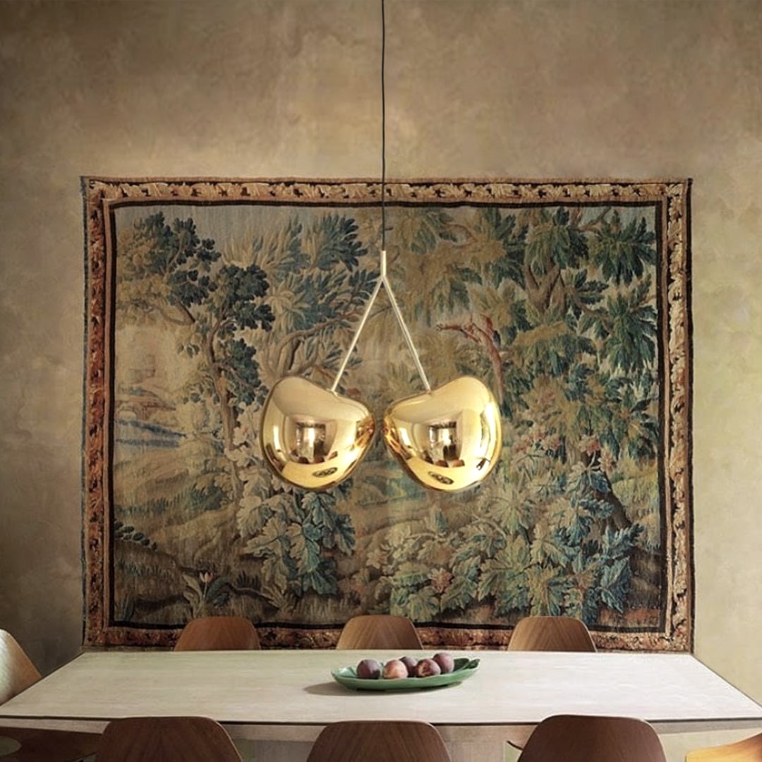 Cherry Pendant Lamp by Qeeboo in gold metal finish displayed in a room with holiday décor.