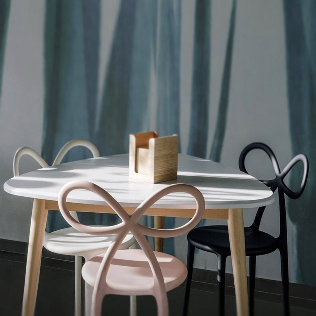 Collage showcasing Ribbon Chair in multiple colors within various modern interiors. Qeeboo Made in Italy