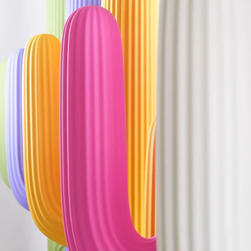 Close‑up of colorful Saguaro Coat Rack variants by Qeeboo, cactus‑inspired sculptural coat racks in modern palette.