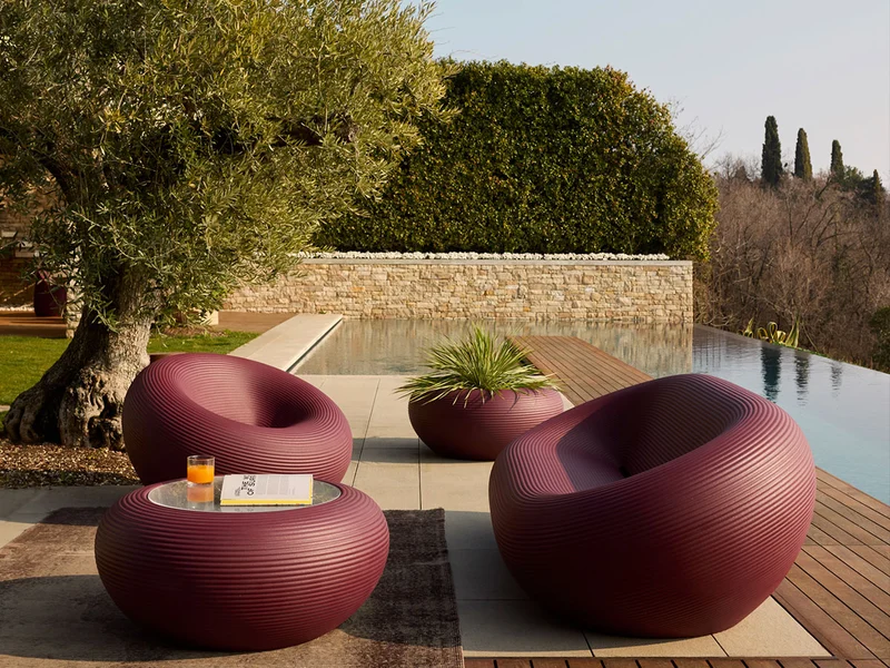 Qeeboo Nami Low Table in outdoor lifestyle scene with modern seating and greenery