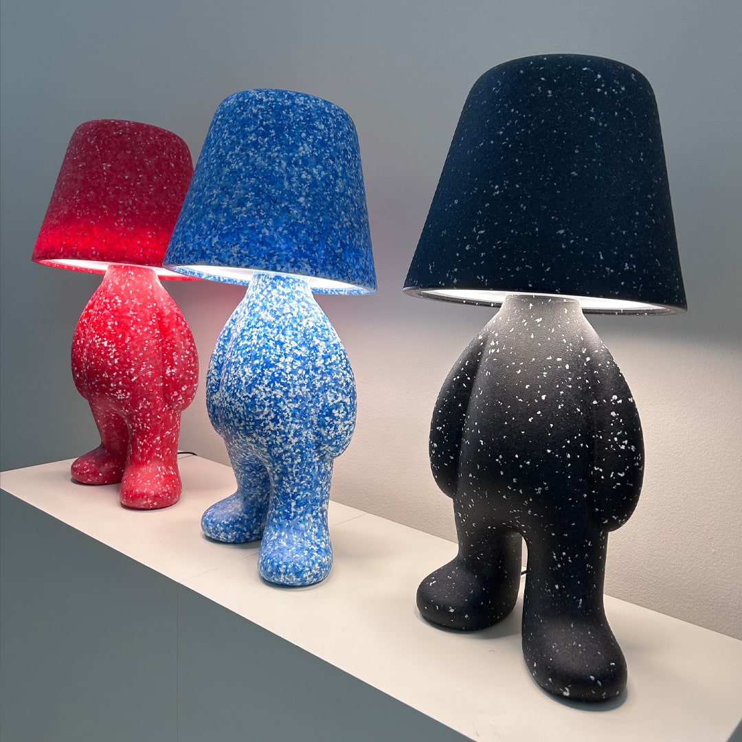 Three Qeeboo unique table lamps with colorful, textured lampshades on a neutral background
