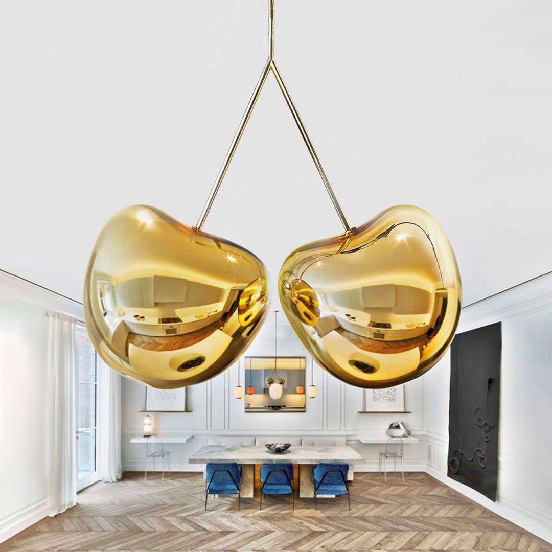 Gold heart-shaped pendant lights in a modern interior setting. Qeeboo Made in Italy