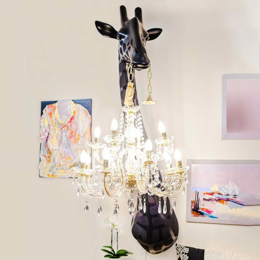 Giraffe-shaped lamp with a chandelier in a living room by Qeeboo