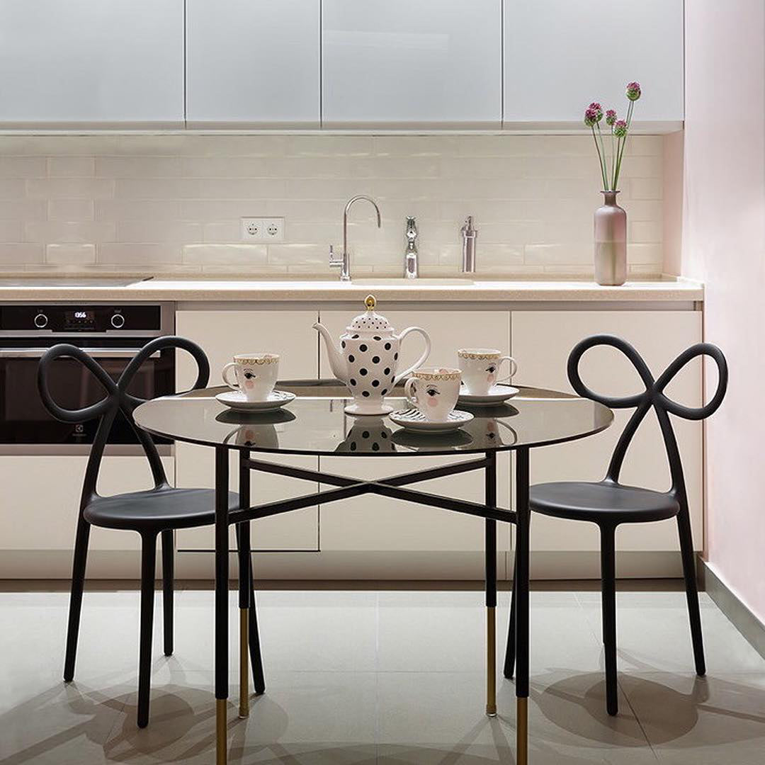 Black Ribbon Chair by Qeeboo styled in a minimalist modern kitchen environment.
