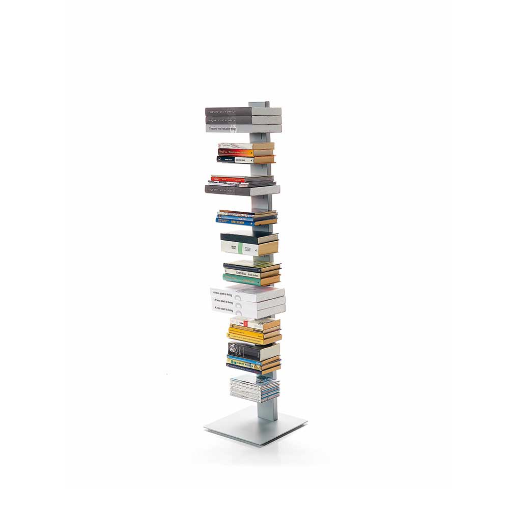 Sapiend modern freestanding book tower shelf with a silver metal base and multiple stacked books in various colors.