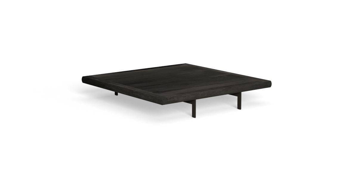 A square coffee table with thin legs and an aluminum shelf, featuring a solid wood top in black.

